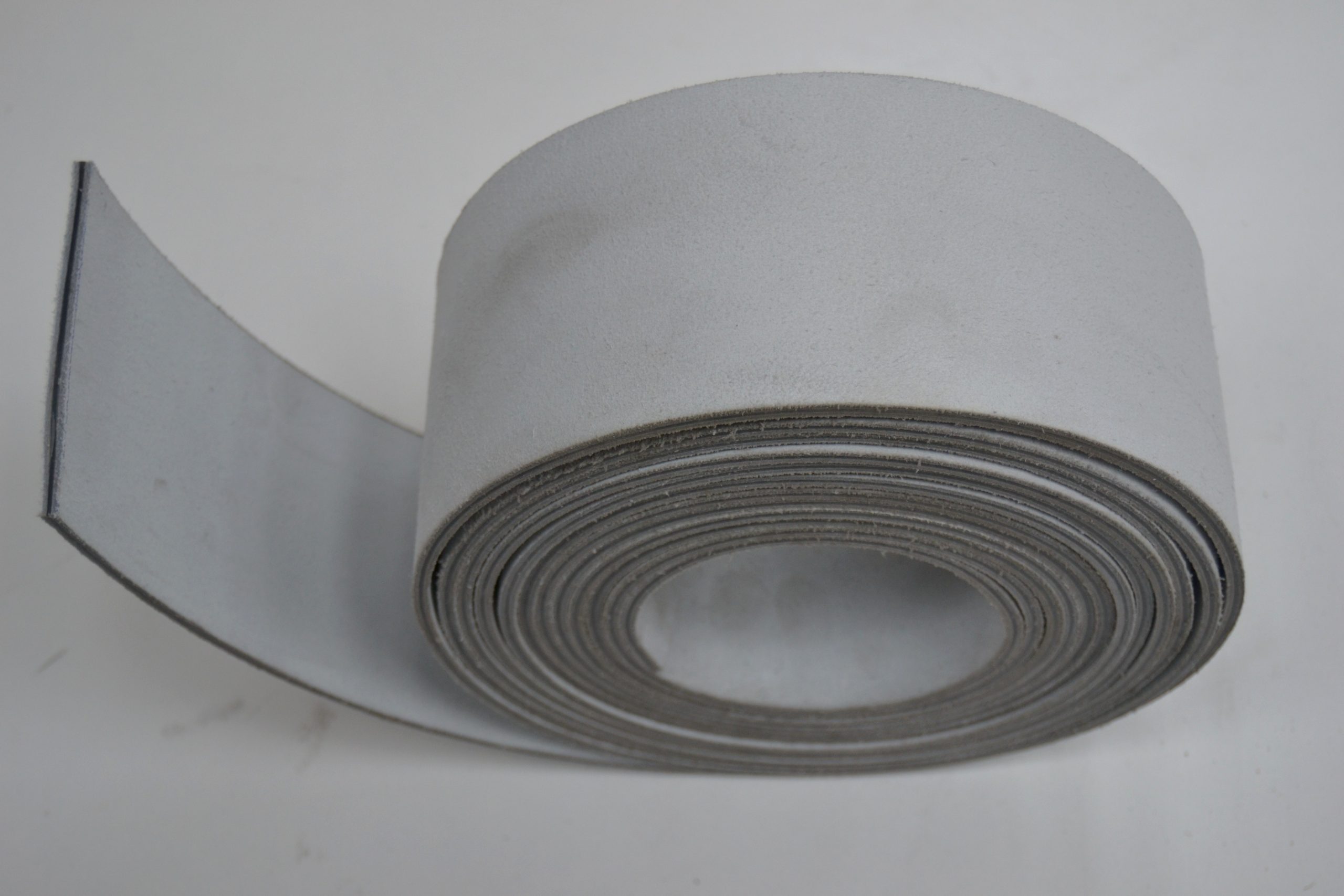 Endless bi-material flat belt
